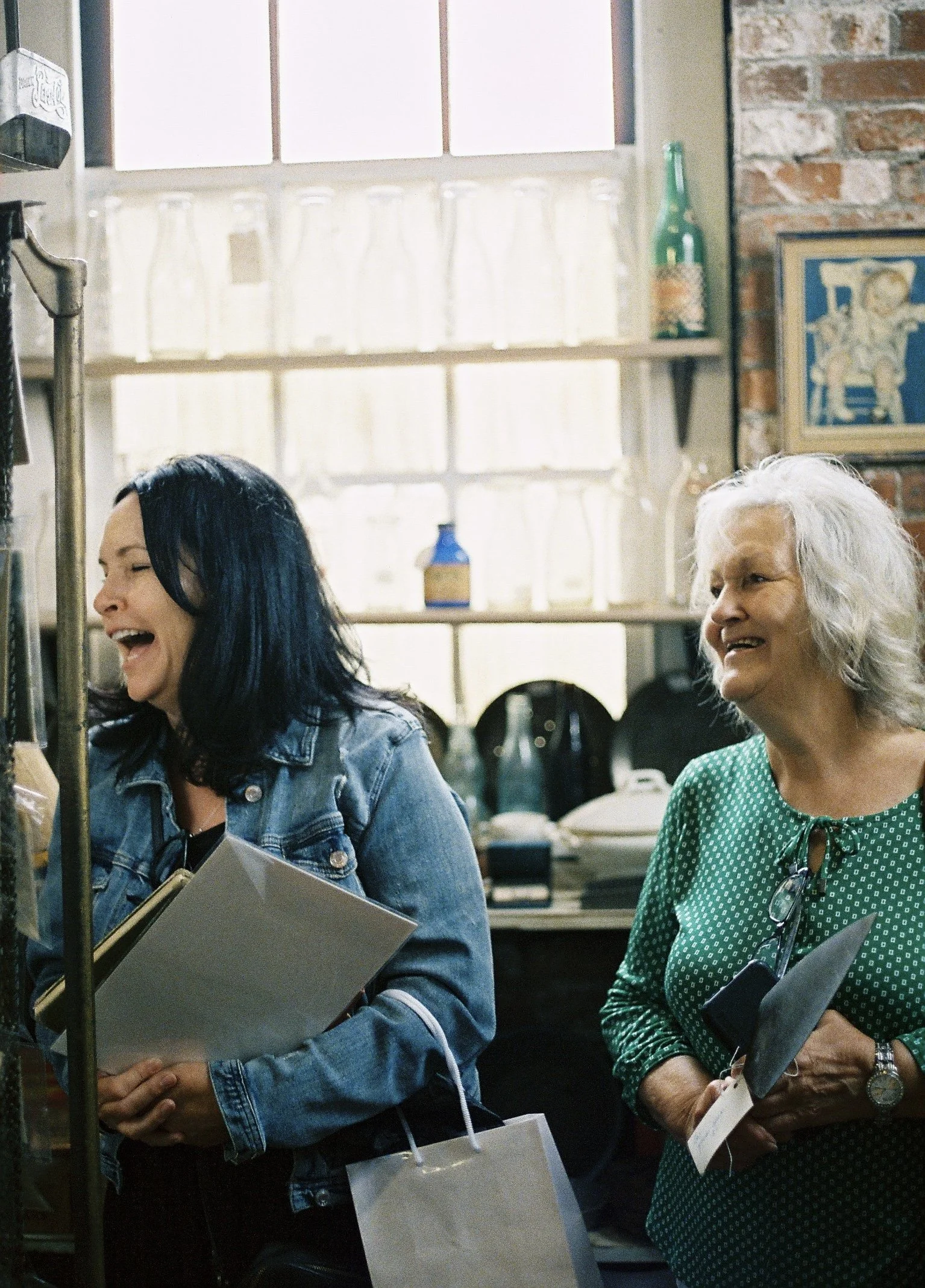 my mom and grandma laughing at themselves trying to pose for the camera