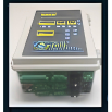 A programmable logic controller (PLC) with an LCD display and multiple input/output ports.