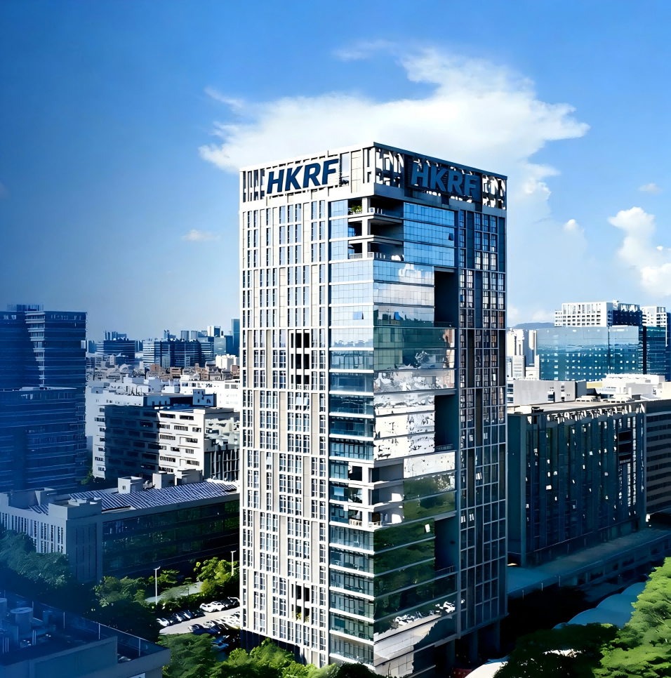 Skyline view of a modern high-rise building with reflective glass windows, located in a city with other tall buildings under a partly cloudy sky.