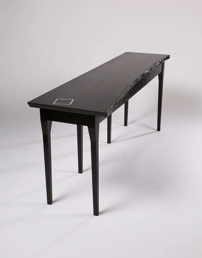 A custom furniture desk with live edge and marble inlay