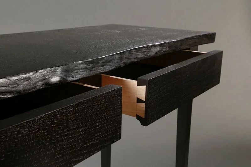 A custom furniture desk with live edge and marble inlay