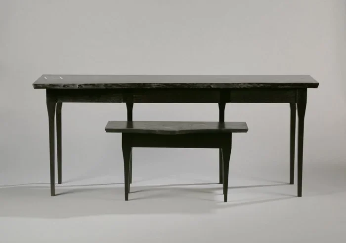 A custom furniture desk with live edge and marble inlay