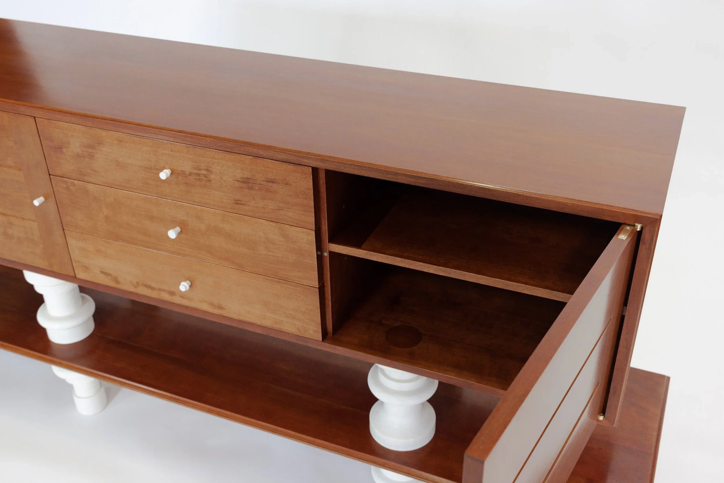 A custom furniture cabinet with turned legs