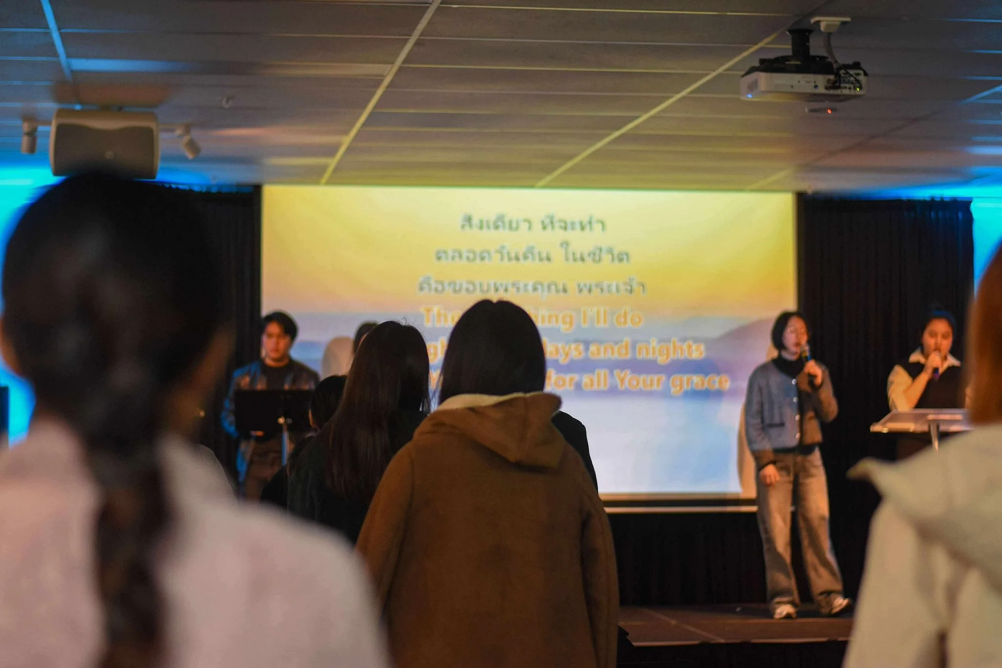 People singing in a Thai worship service.