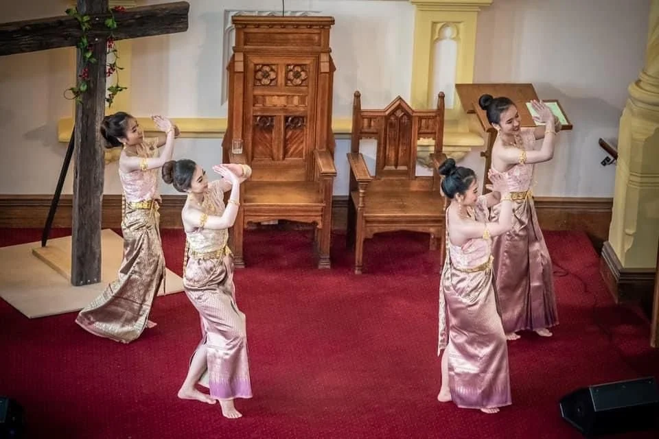 Four Thai women dancing in traditional dress