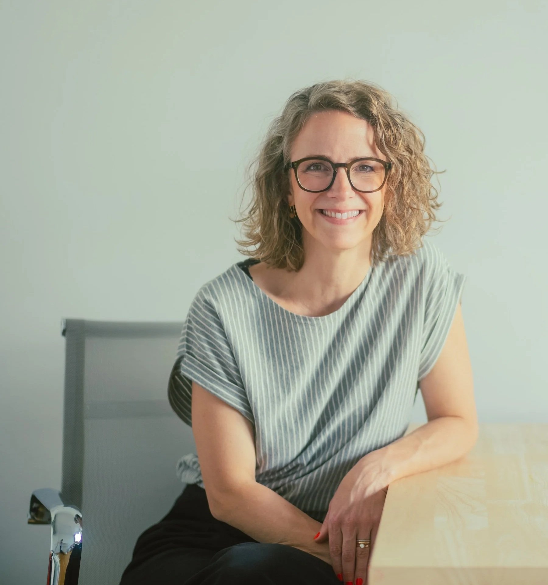 Elena Kirchberg speaking at an event — coach, lawyer, and founder of 50/50 Club