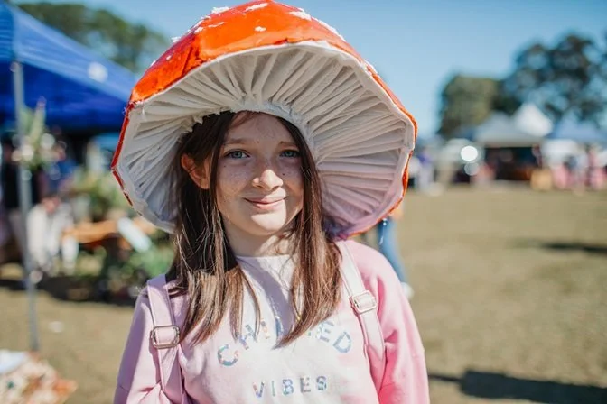 HerbFest smiling girl in mushroom hat.jpg