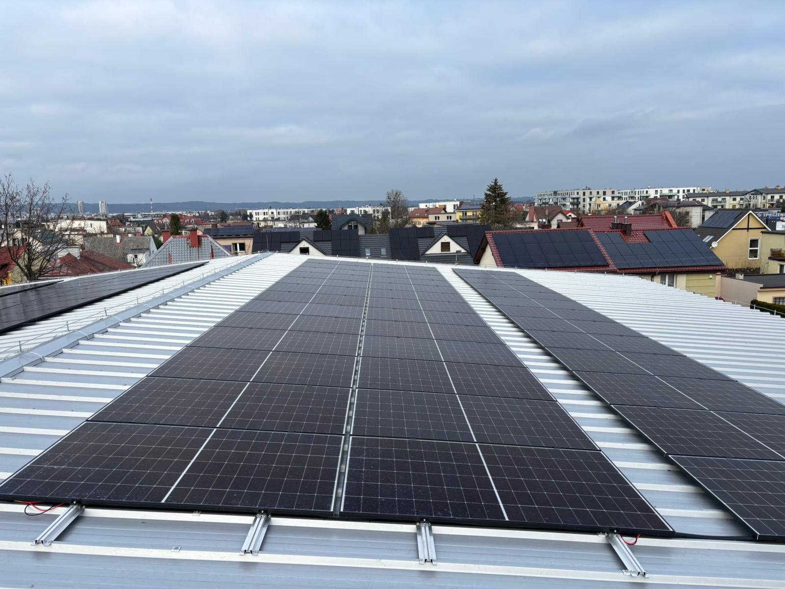 solar panels installed on the metal roof of a building.