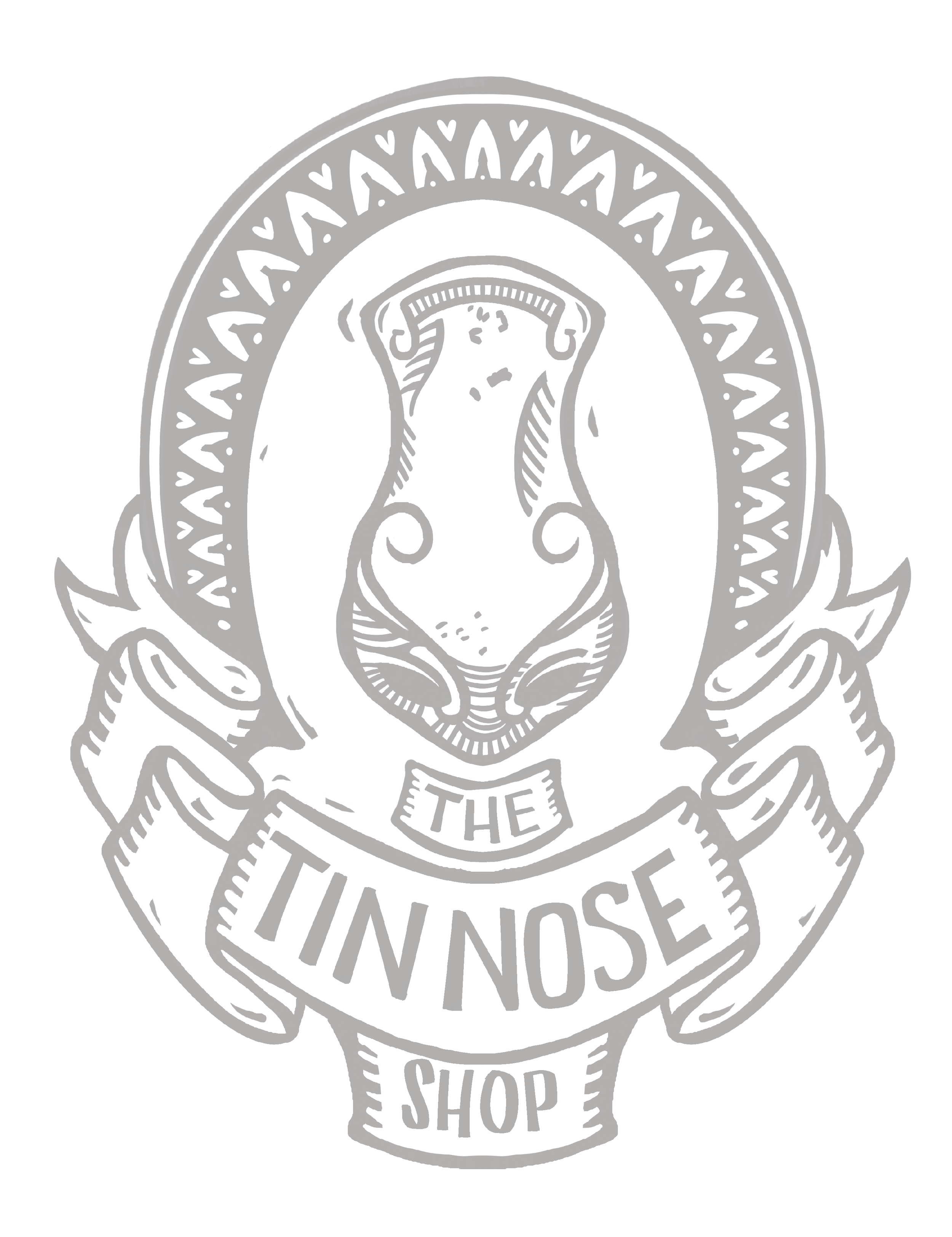 A logo with a pig's head in the center, surrounded by a circular border. Below the pig's head, there is a ribbon banner with the text 'THE TIN NOSE SHOP'.