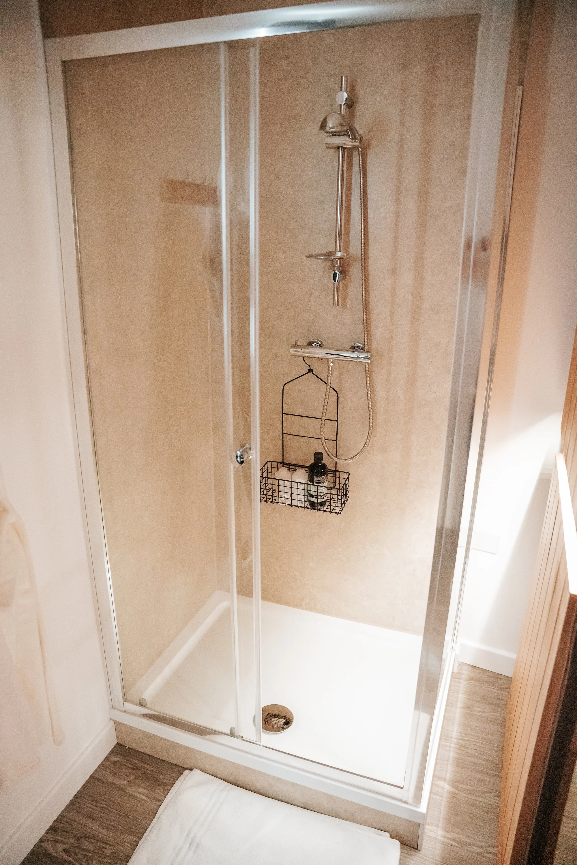 A modern shower situated in a sauna treatment room