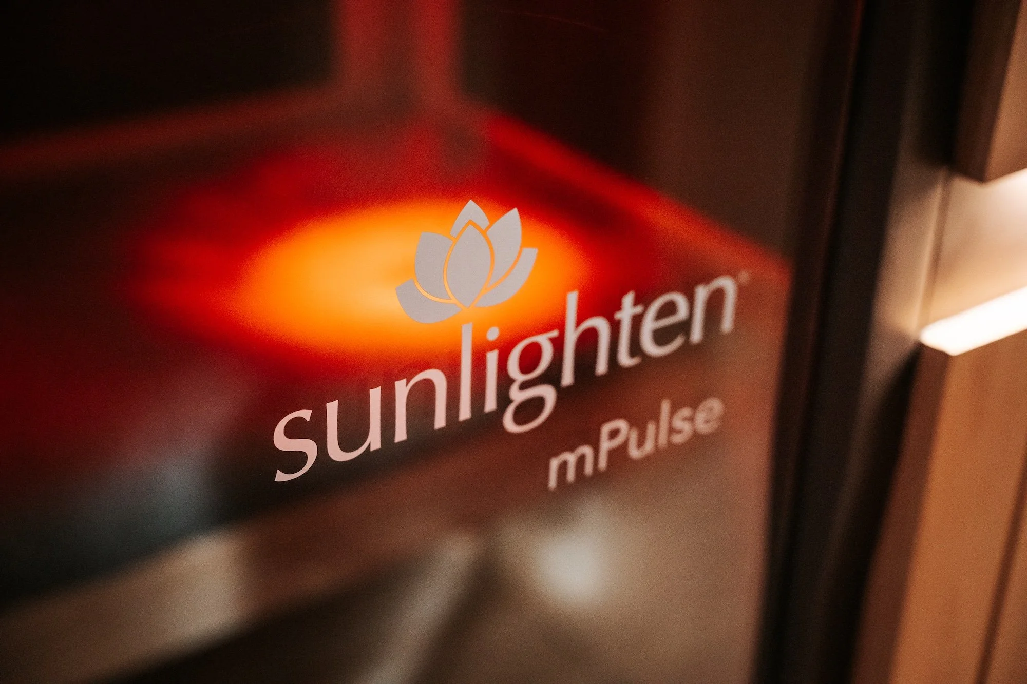 A close up of Sunlighten logo on infrared sauna