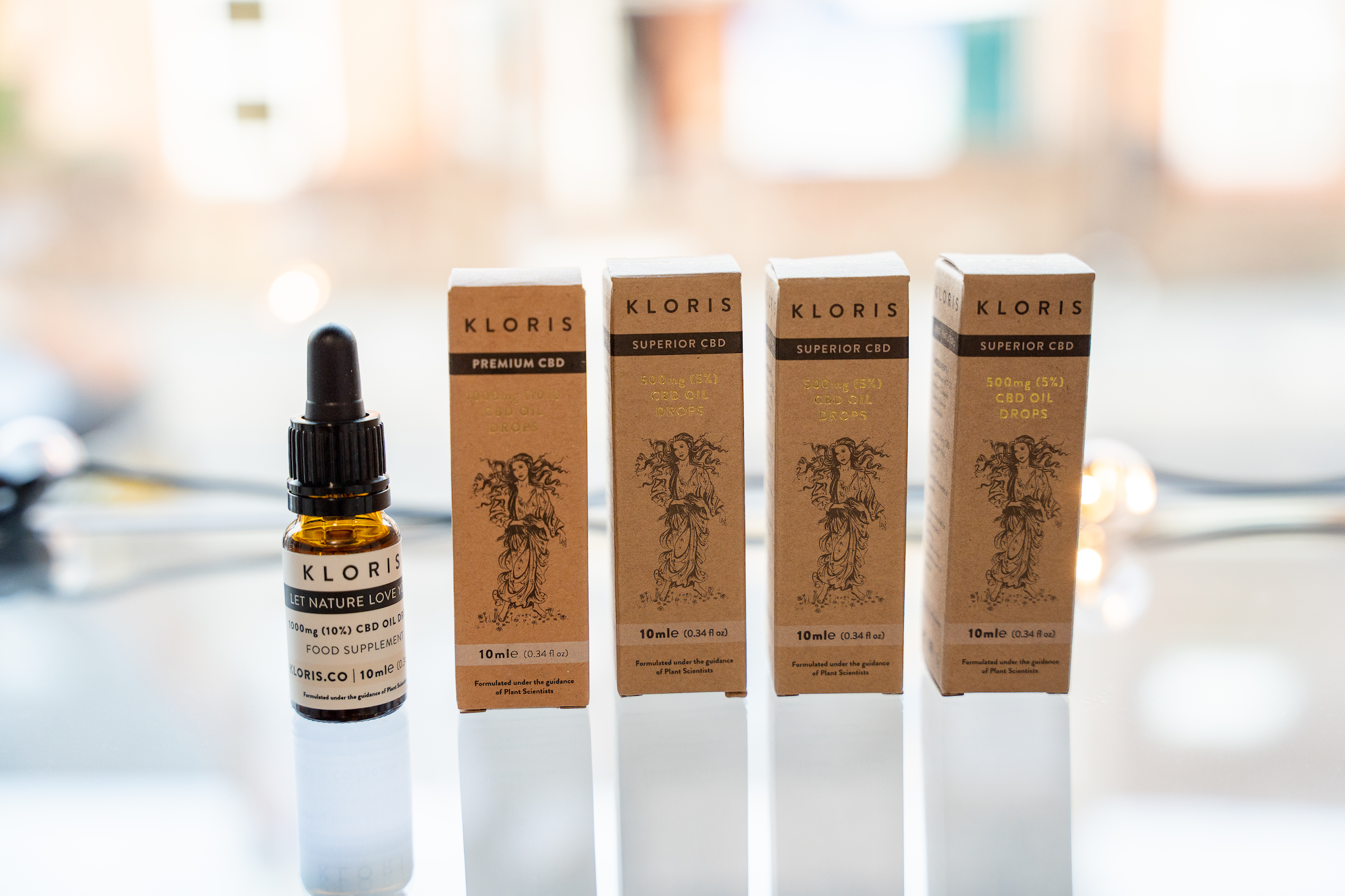 Kloris CBD oil products lined up on a glass shelf