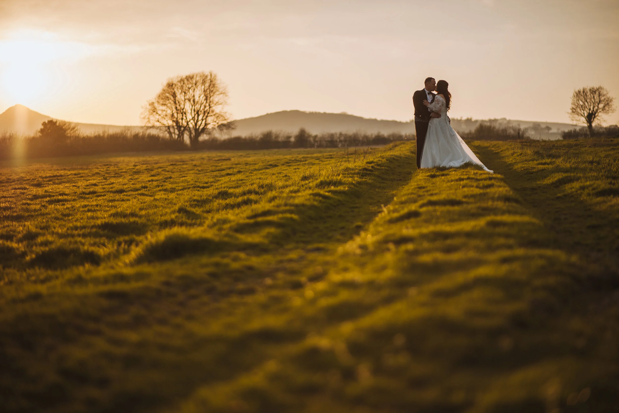 Bride and groom at wedding in Cornwall at sunset golden hour captured by Cornwall wedding photographer Mark Shaw Photography