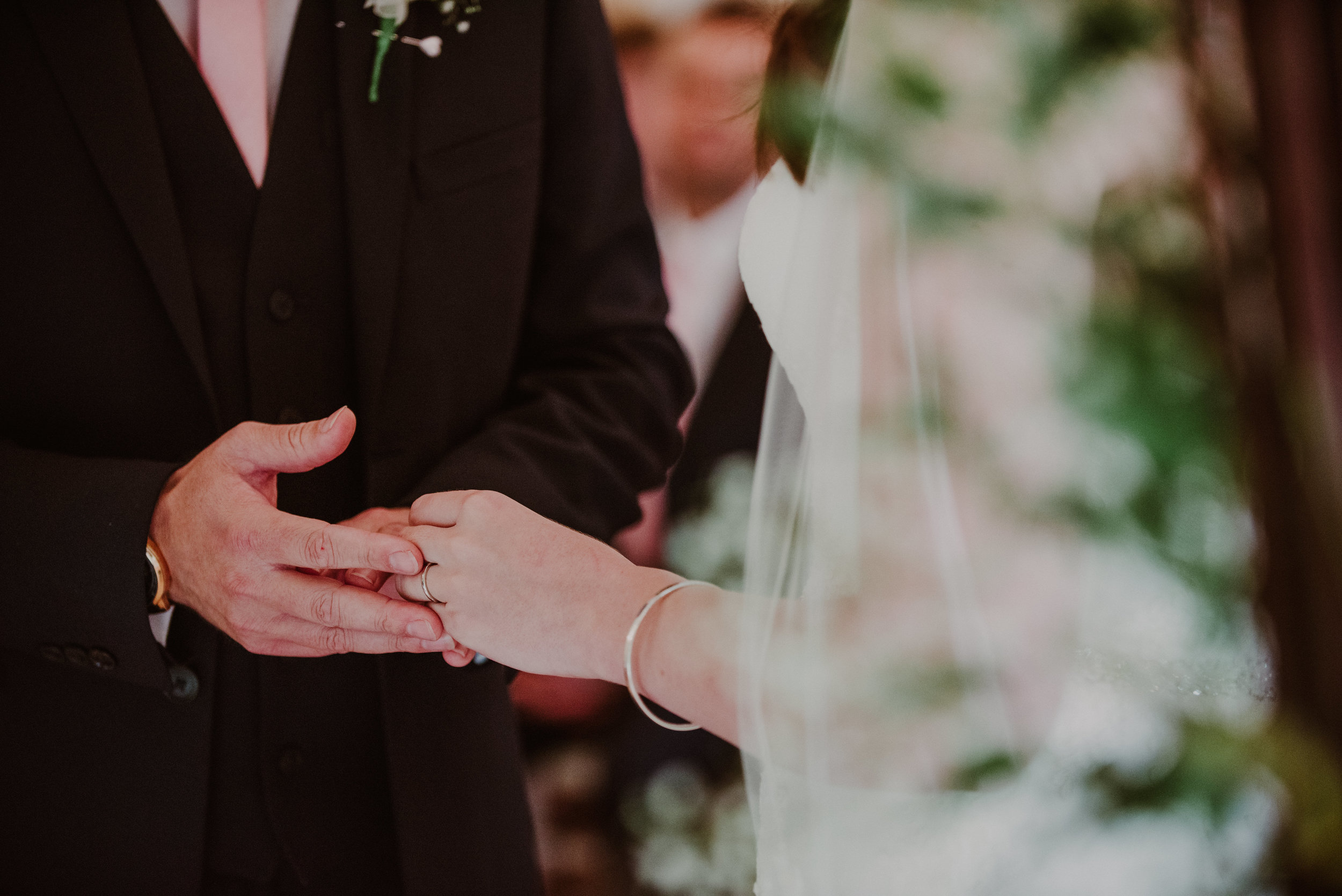 A bride and groom holding hands during a wedding ceremony.