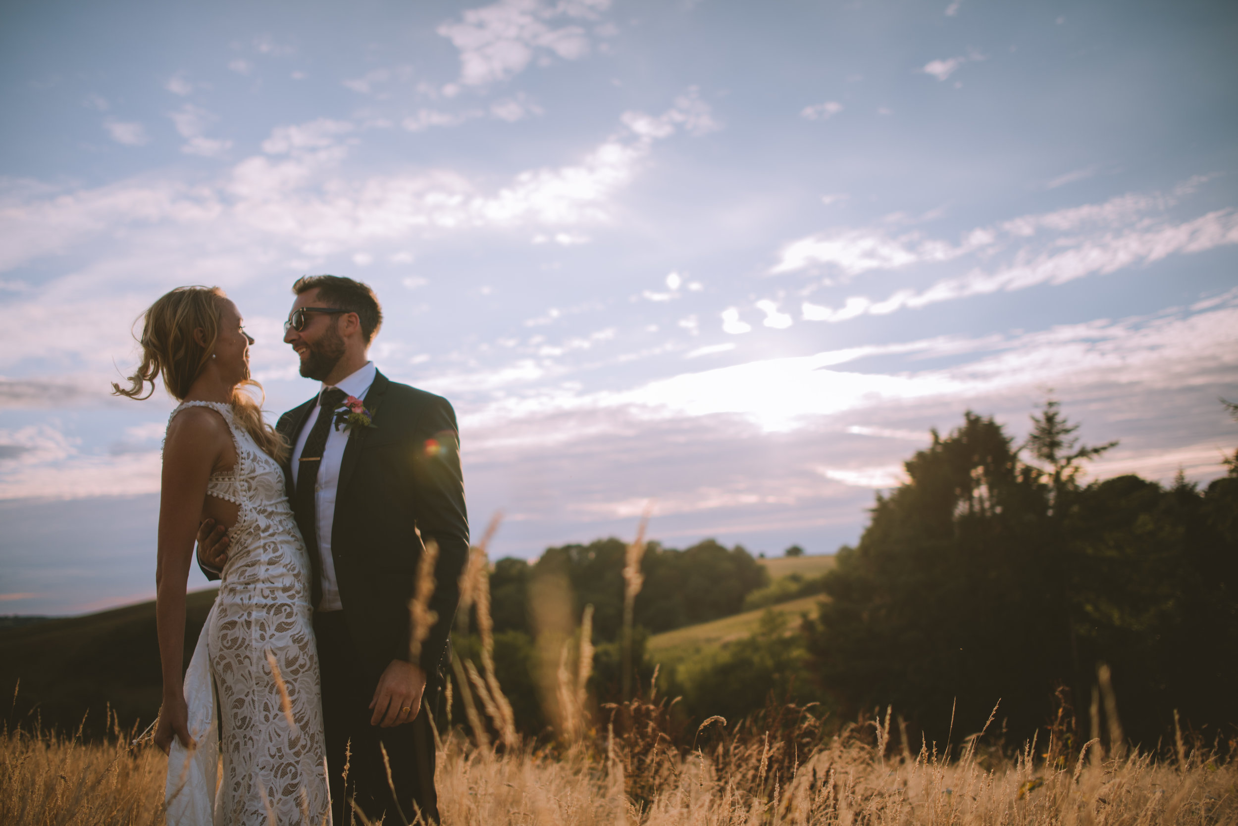 Bride and groom at wedding in Cornwall at sunset golden hour captured by Cornwall wedding photographer Mark Shaw Photography
