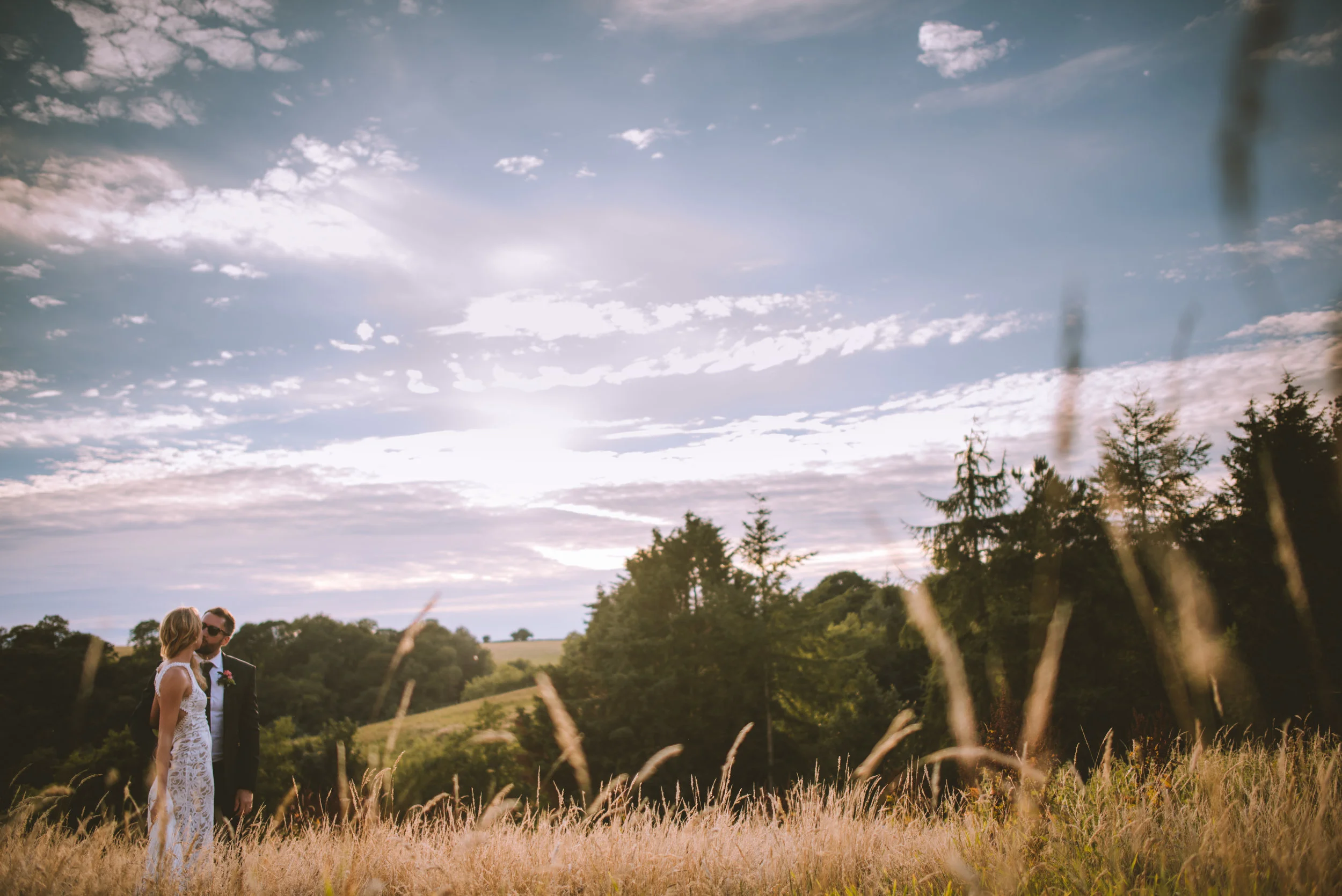 Bride and groom at wedding in Cornwall at sunset golden hour captured by Cornwall wedding photographer Mark Shaw Photography