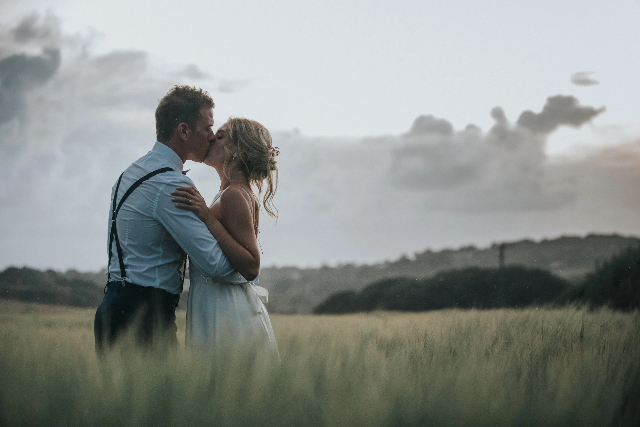 Bride and groom in fields at Launcells Barton in Bude, captured by Cornwall wedding photographer Mark Shaw Photography