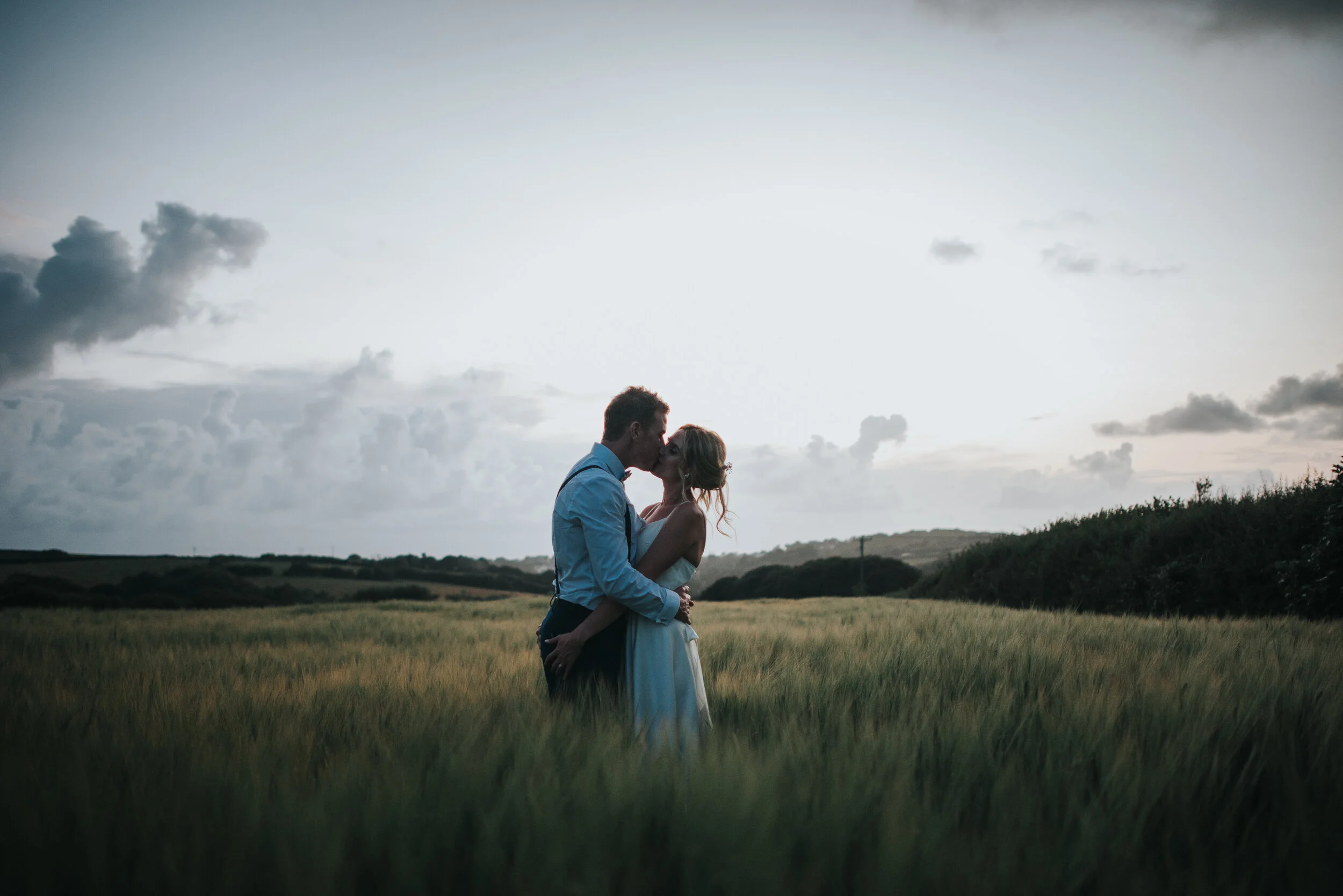 Bride and groom in fields at Launcells Barton in Bude, captured by Cornwall wedding photographer Mark Shaw Photography