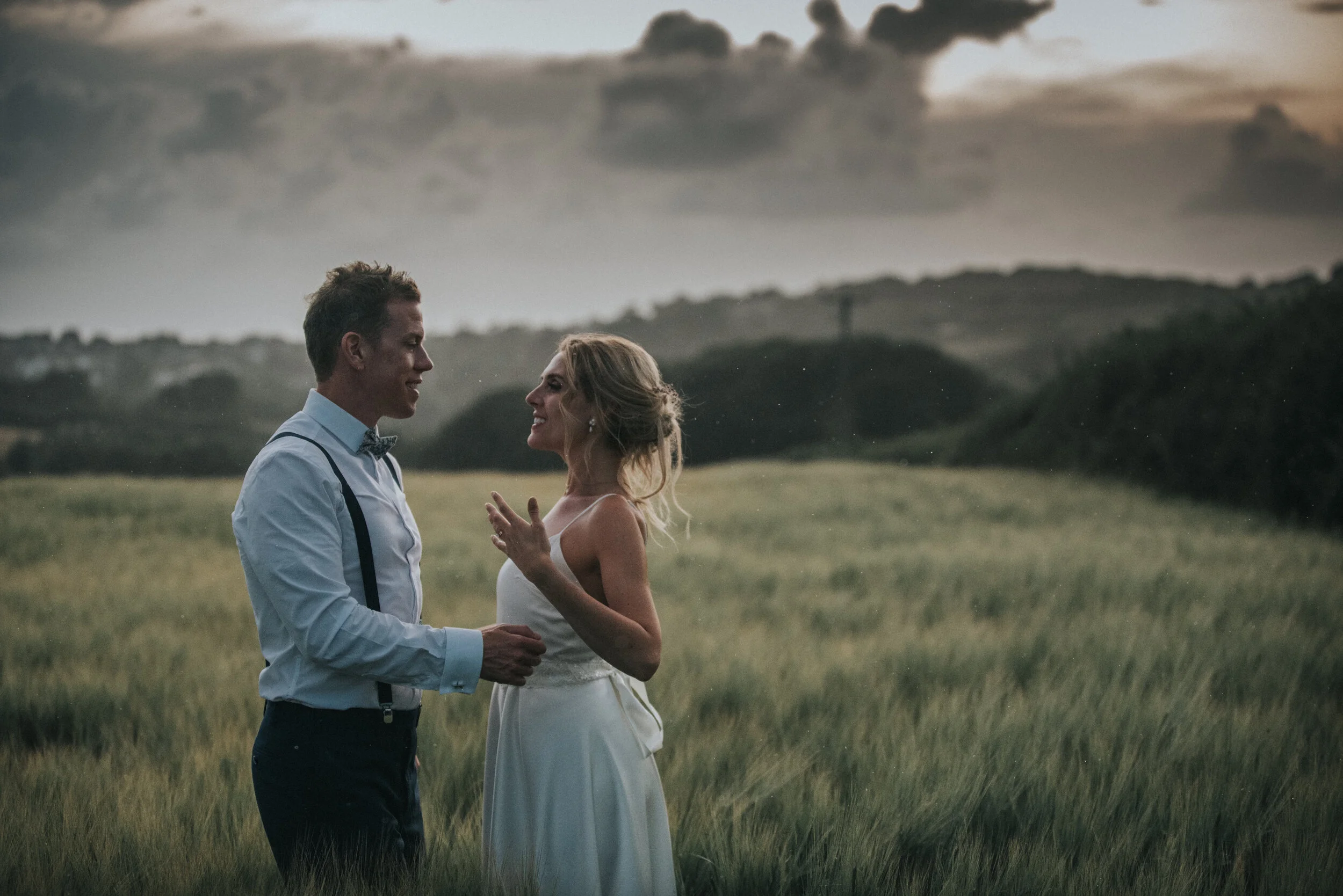 Bride and groom in fields at Launcells Barton in Bude, captured by Cornwall wedding photographer Mark Shaw Photography