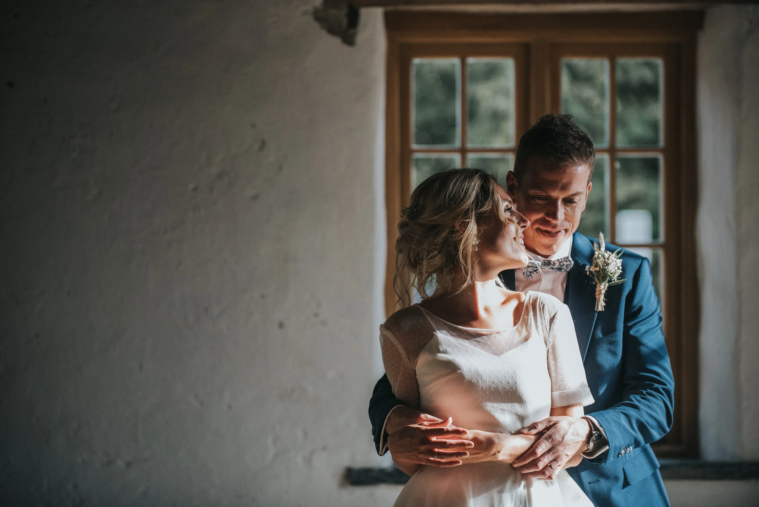 A bride and groom share an intimate moment at Launcells Barton in Bude, captured by Cornwall wedding photographer Mark Shaw Photography