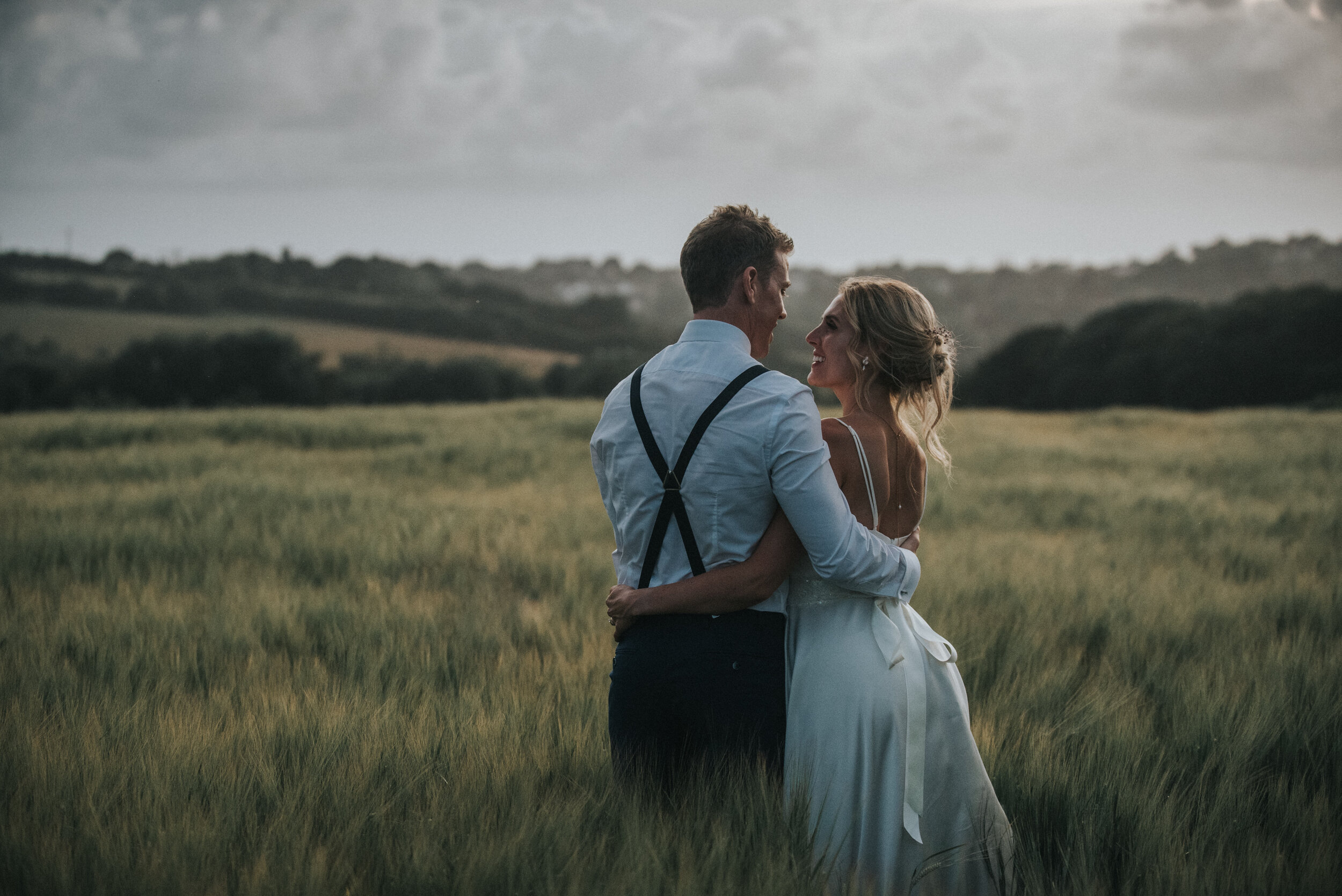 Bride and groom in fields at Launcells Barton in Bude, captured by Cornwall wedding photographer Mark Shaw Photography