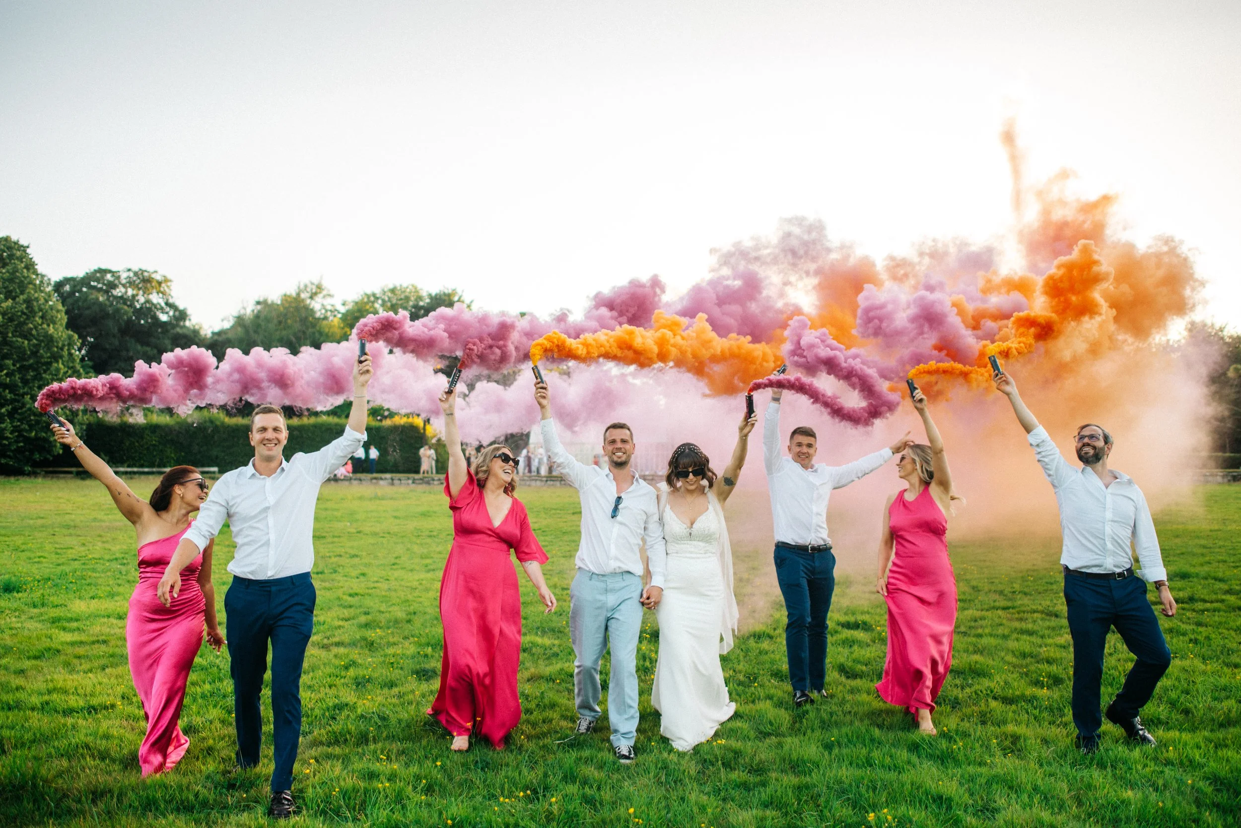 Wedding party with smoke grenades at Scorrier House captured by Cornwall based wedding photographer Mark Shaw Photography.