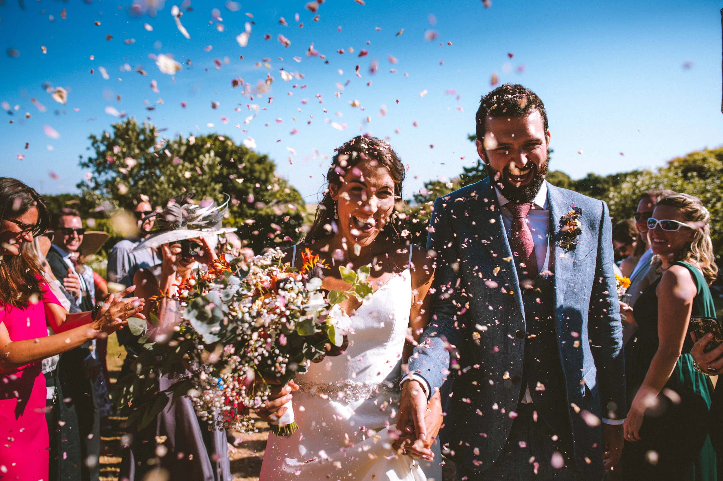 Confetti photo of bride and groom and guests at wedding in Devon 