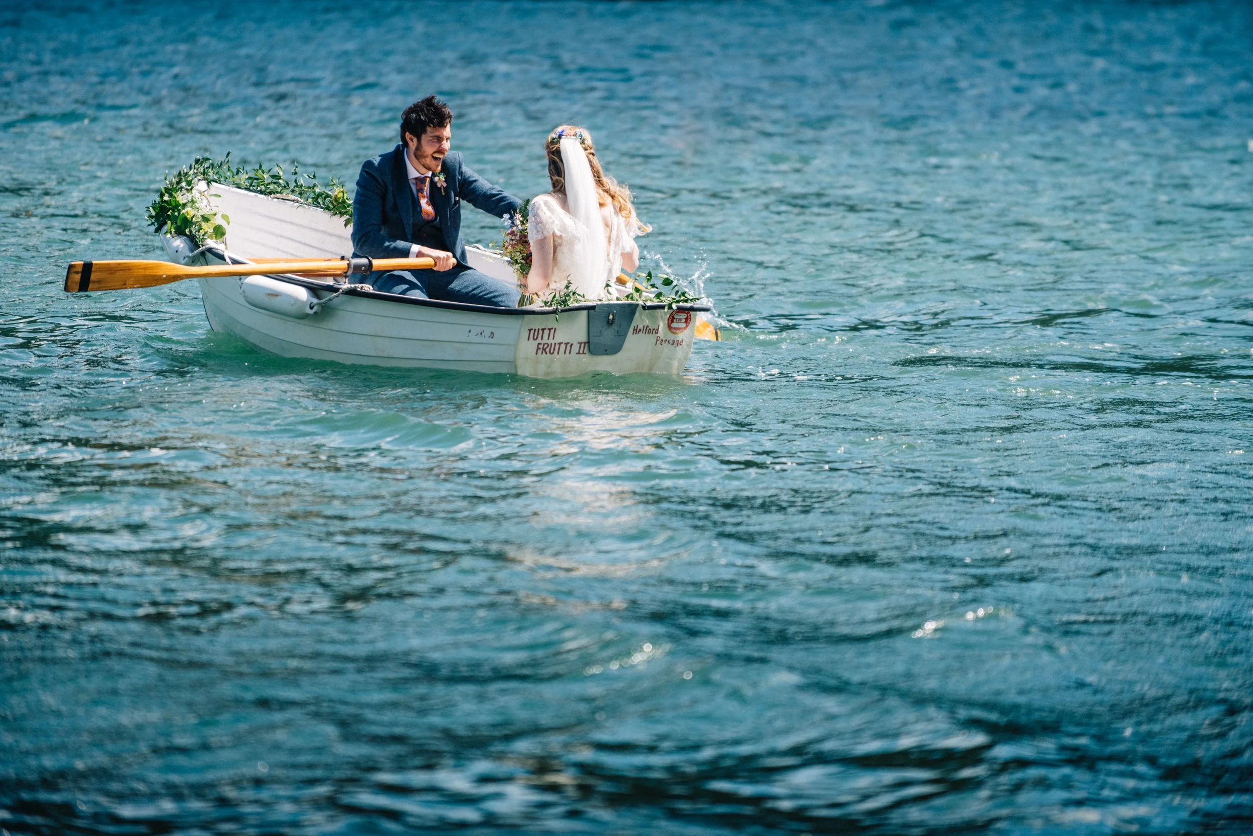 Bride and groom in a rowboat on a lake