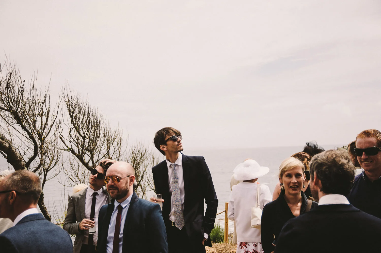 Guests at an outdoor wedding on the coast, captured by award-winning Cornwall wedding photographer, Mark Shaw. 