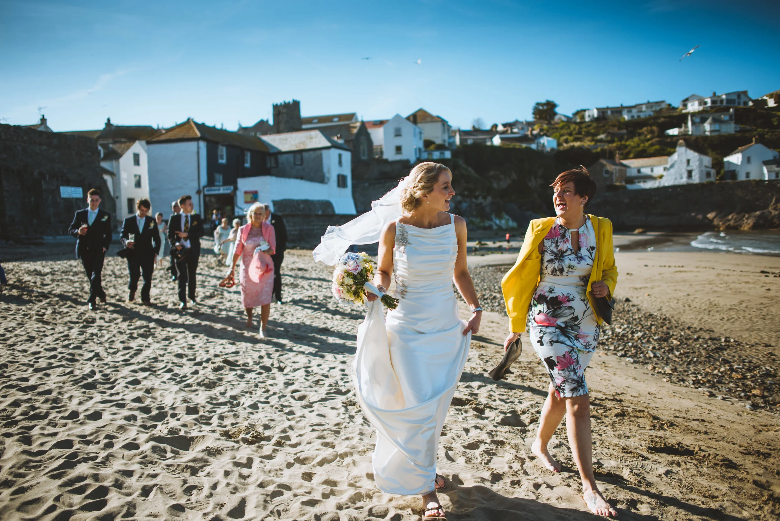 Bride and guests on beach captured by Cornwall wedding photographer Mark Shaw Photography