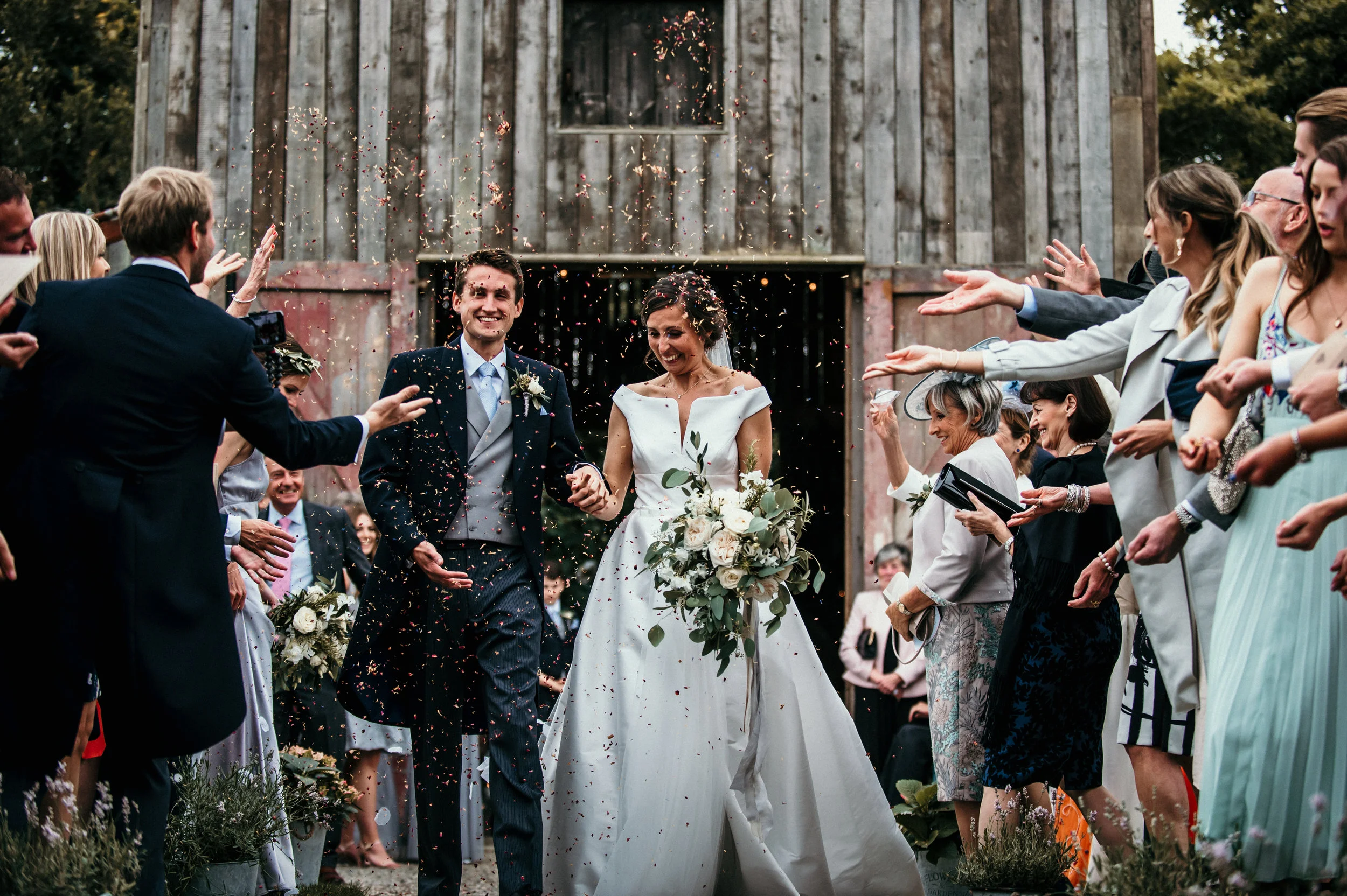 Bride and groom confetti at Nancarrow Farm captured by Cornwall wedding photographer Mark Shaw Photography 