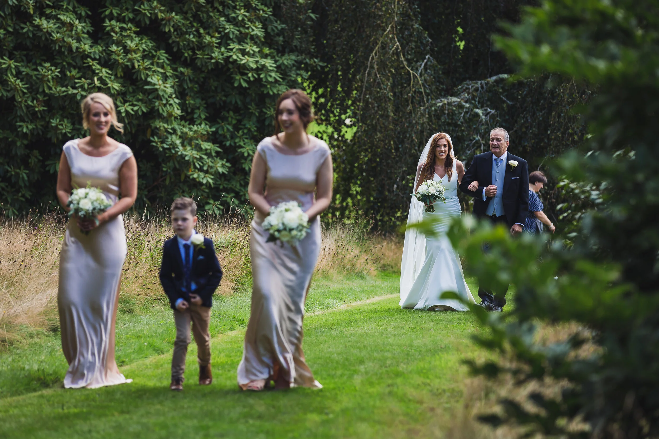 A wedding procession at Boconnoc in Cornwall by wedding photographer Mark Shaw Photography 