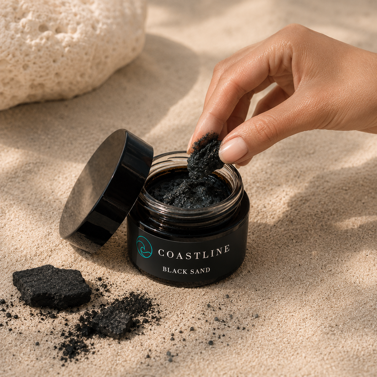 coastline-clear-black-sand-exfoliant-hand2.png