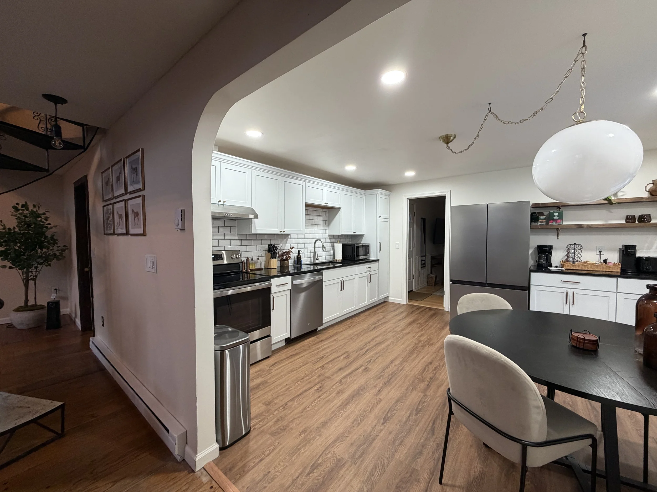 Full kitchen renovation with new flooring, cabinets, backsplash tile, and finished drywall in Florence, Massachusetts.
