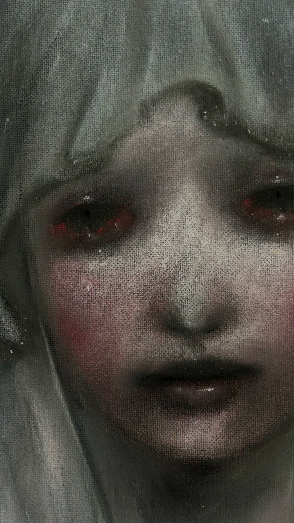 Close-up of a face behind a veil or screen, with pale makeup, red eyes, and slightly parted lips.