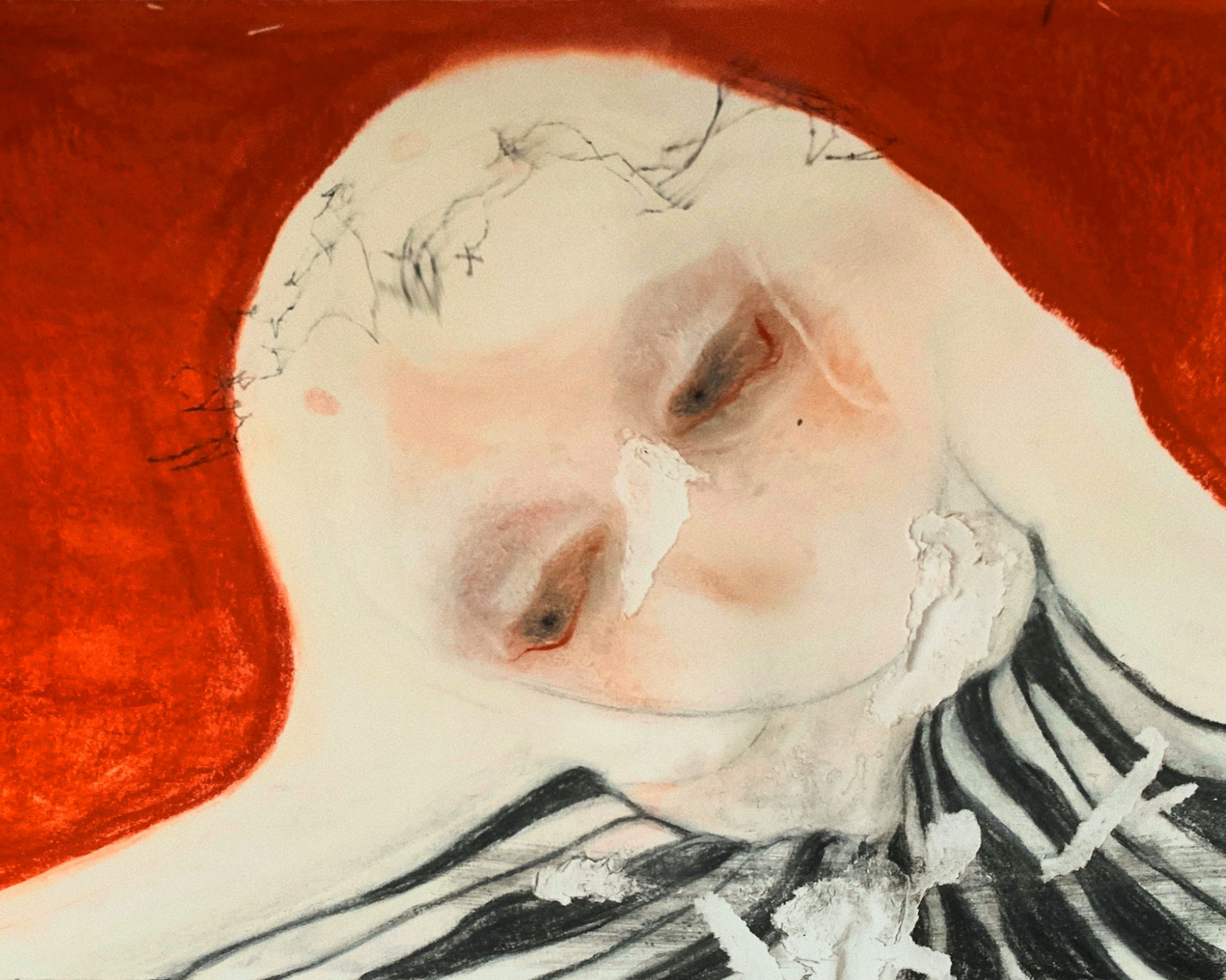 Close-up of a person's face with their eyes closed, wearing a red hood and a black and white striped shirt, with some damaged paper or tissue near the face.