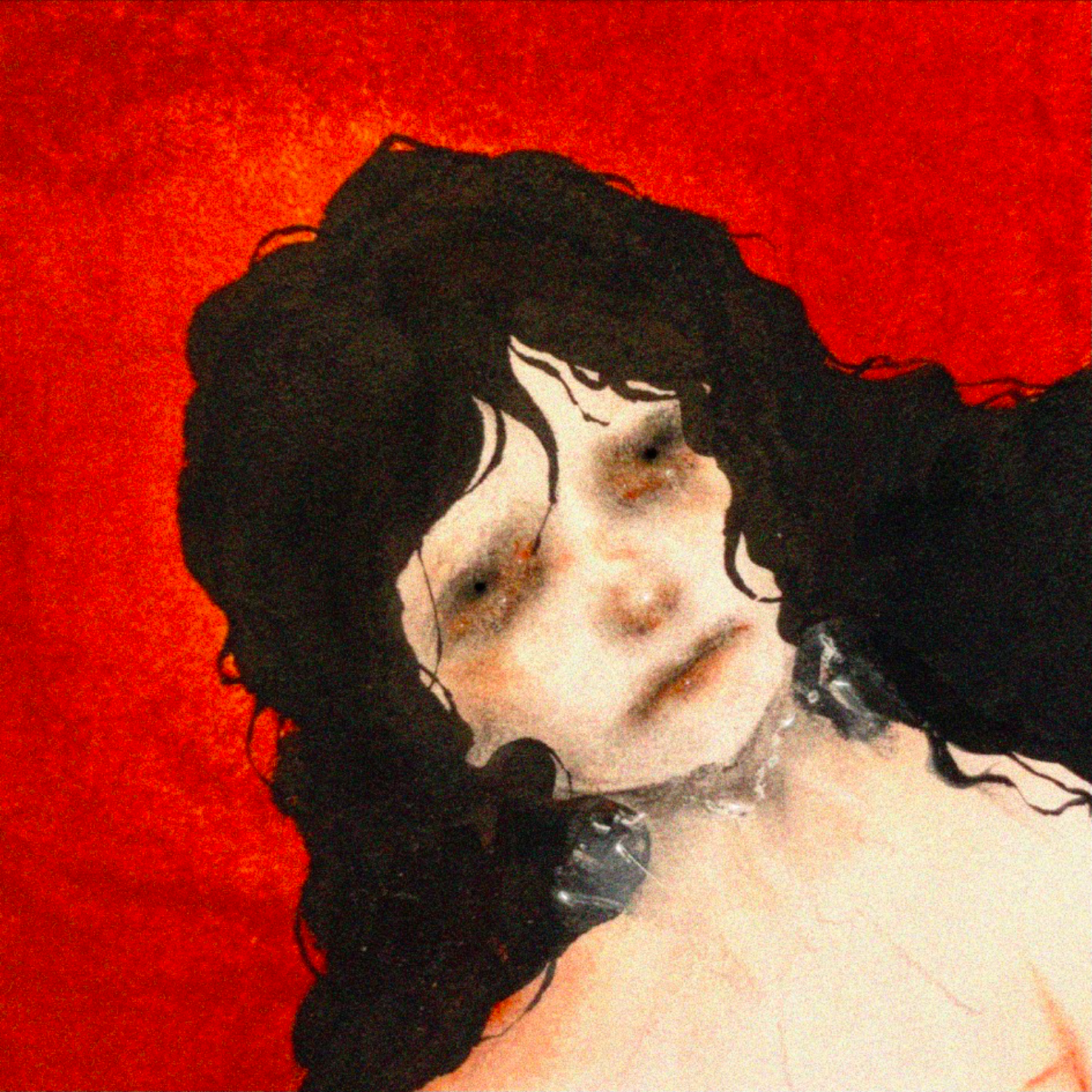 A close-up of a person's face with curly black hair, freckles, and a light skin tone, set against a red background.