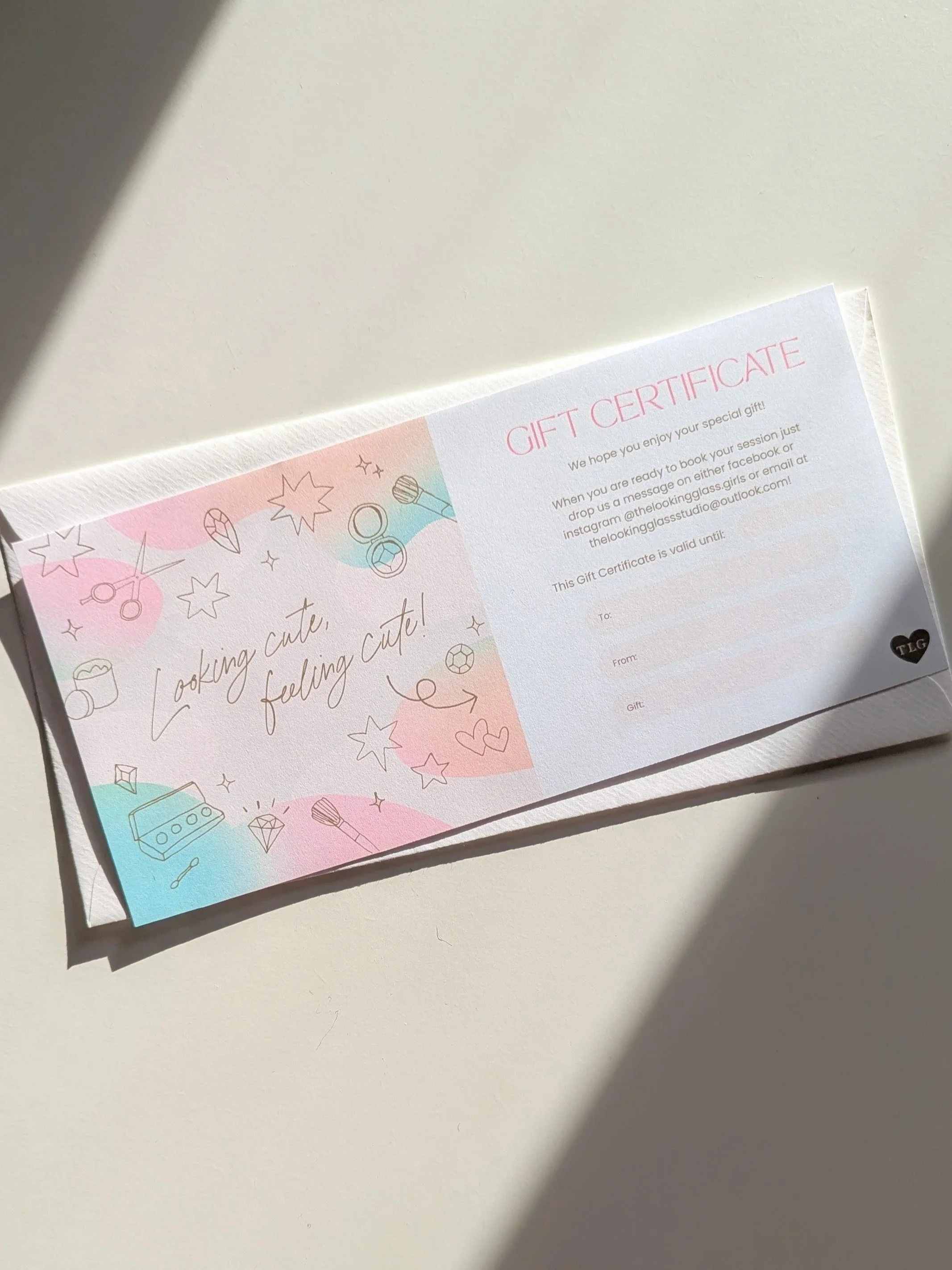 A pastel-colored gift certificate with illustrations of scissors, stars, diamonds, lipstick, and hearts, and the text 'Looking cute, feeling cute!' with a section for recipient and giver information on a light background.