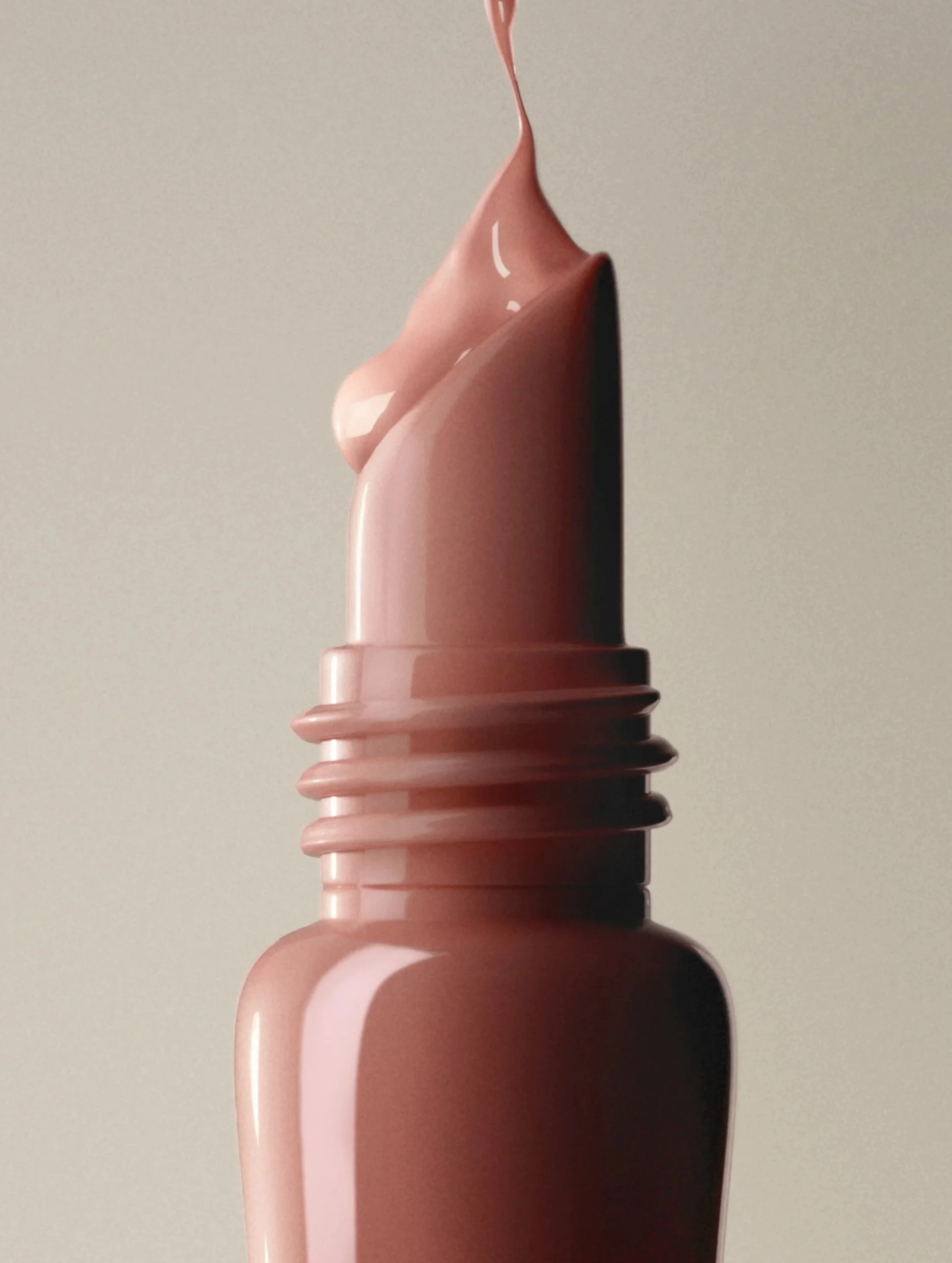 Close-up image of a soft-serve ice cream cone with pink ice cream and a dark chocolate tip, with a plain background.