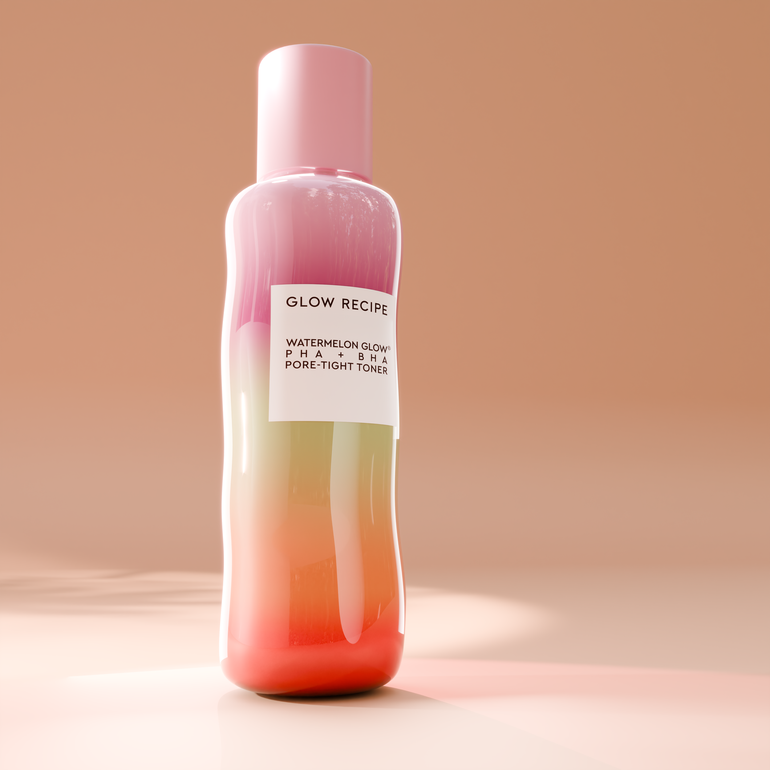 A pink and white bottle of Glow Recipe Watermelon Glow PHA + BHA Pore-Tight Toner standing on a light pink surface with a beige background.