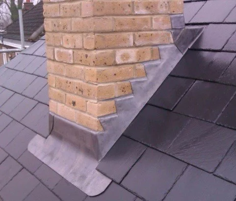 Close-up of a brick chimney detailing lead step flashing