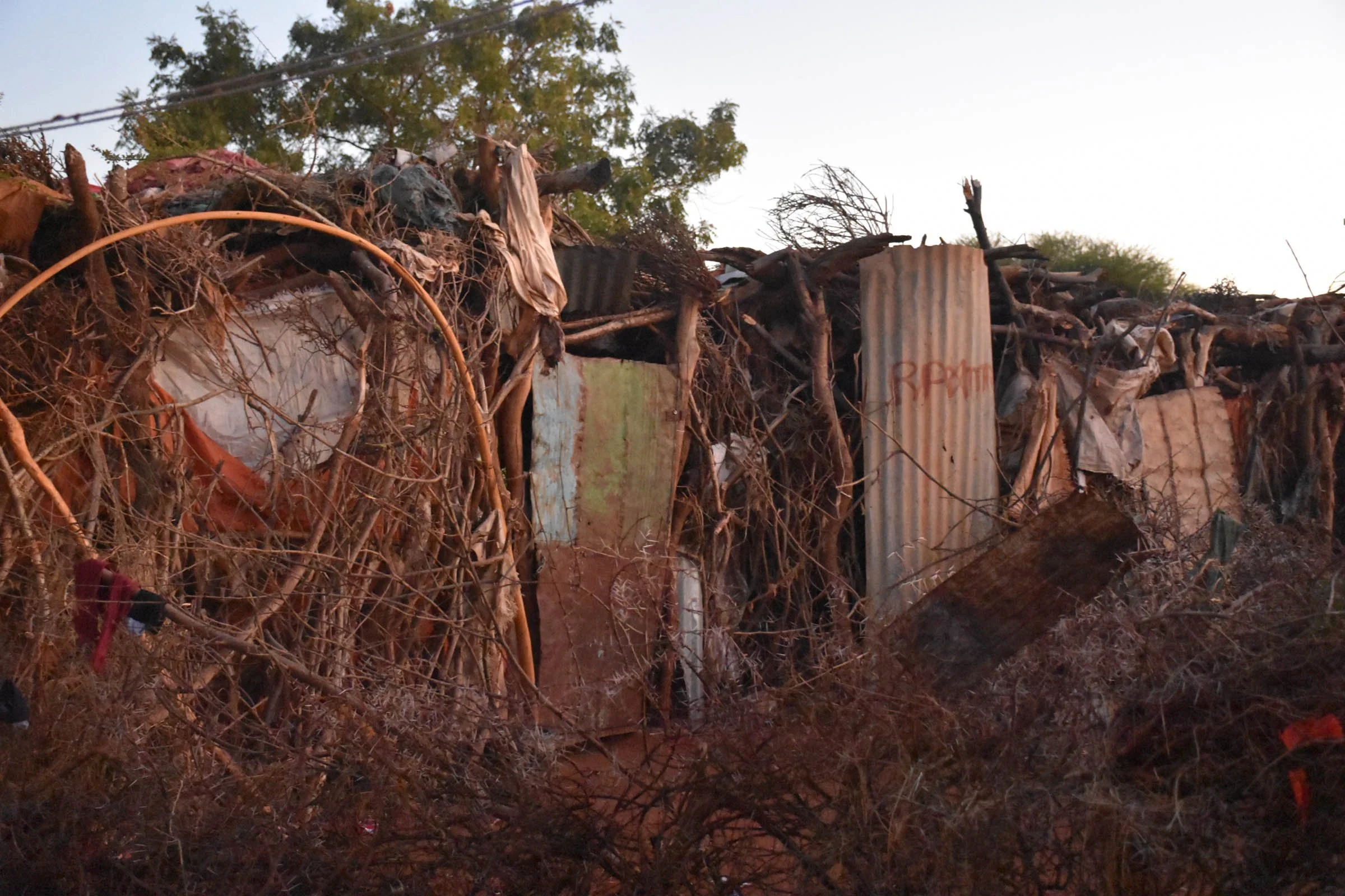 Thorn fencing surrounds a village home