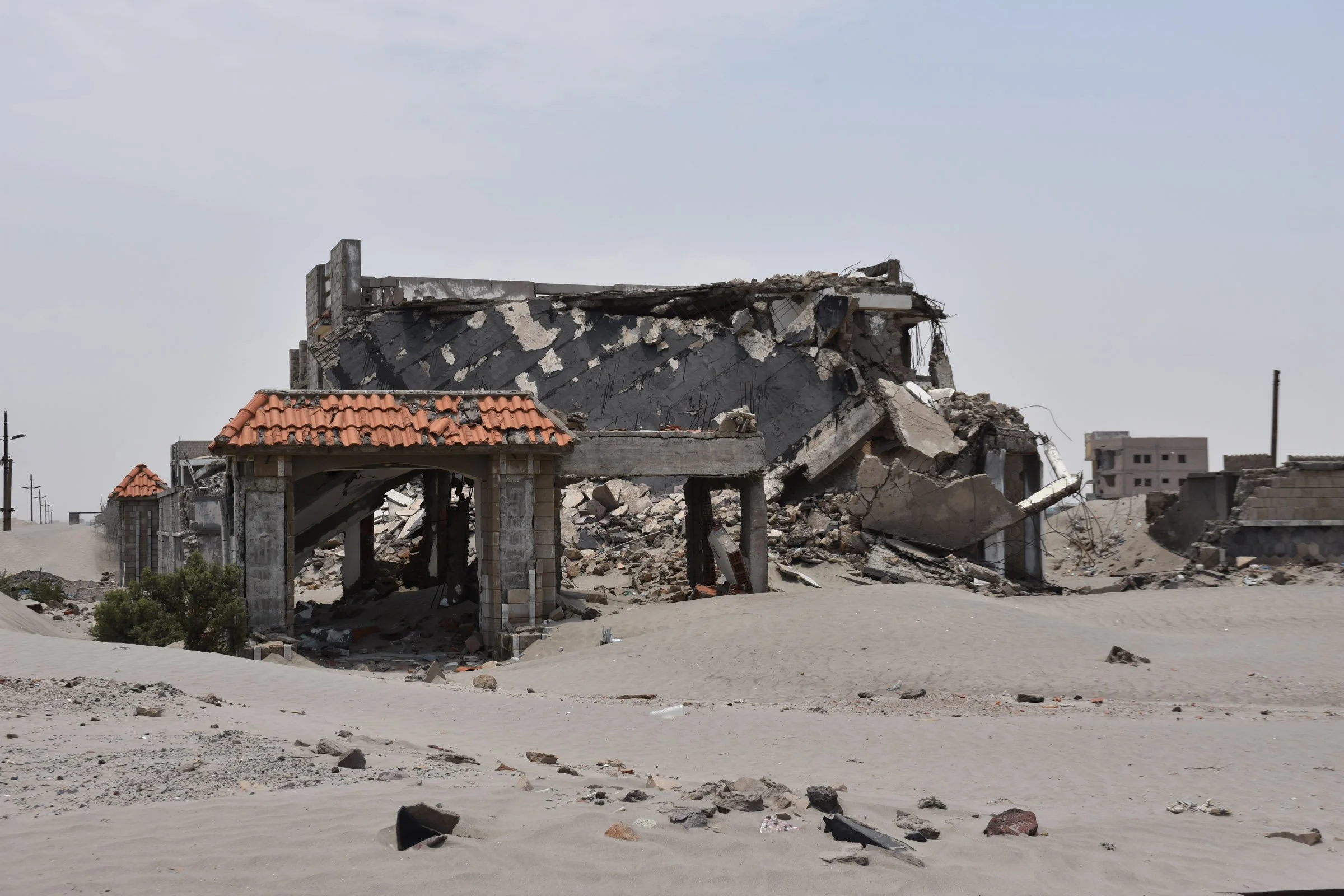 A destroyed building on sand
