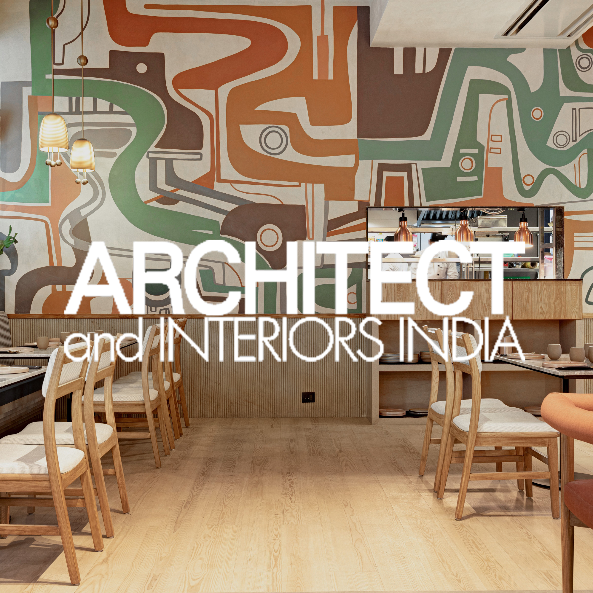 Interior of a restaurant featuring a wooden floor, wooden chairs with light cushions, a mural with abstract shapes and colors on the wall, and a kitchen area visible through a window. Overlaid text reads 'ARCHITECT and INTERIORS IN INDIA'.