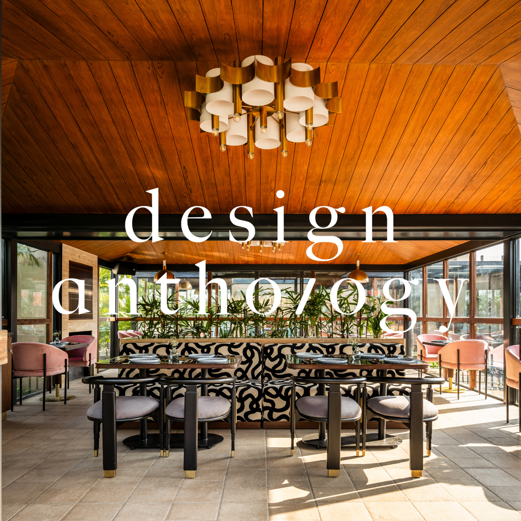 Interior of a modern restaurant with a wooden ceiling, pink chairs, black and white patterned dividers, and large windows letting in natural light. Overlaid with the white text 'design anthropology'.