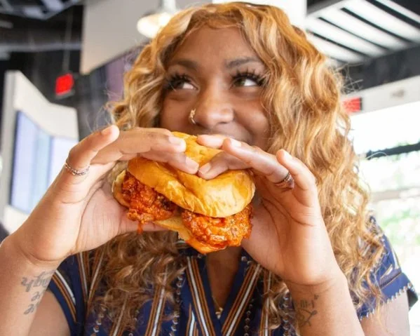 A woman holding a hamburger