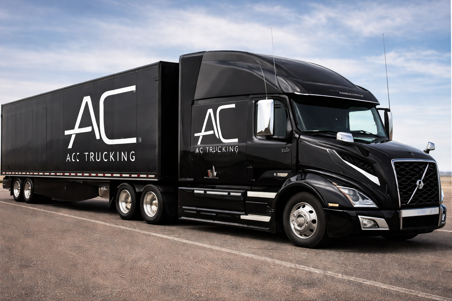 Black AC Trucking semi-truck parked on an open road, with the company logo and name on the side, under a partly cloudy sky.