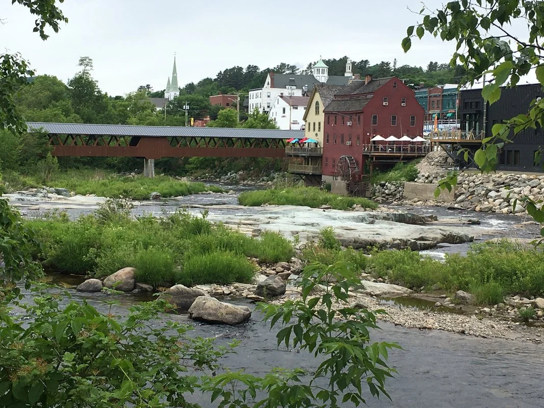 Dine, drink coffee or have a celebratory local brew with a river and bridge view in Littleton