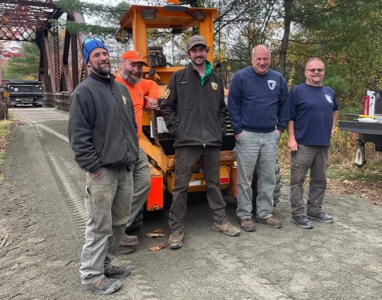 Here is the NH Bureau of Trails team that finished the last 500 feet of surfacing between the 2 trestle bridges. They brought in small dump trucks from their offices in each corner of the state to finish the job. The contractor's BIG dump trucks deli