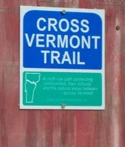 Blue and green sign for Cross Vermont Trail, with a map outline of Vermont.